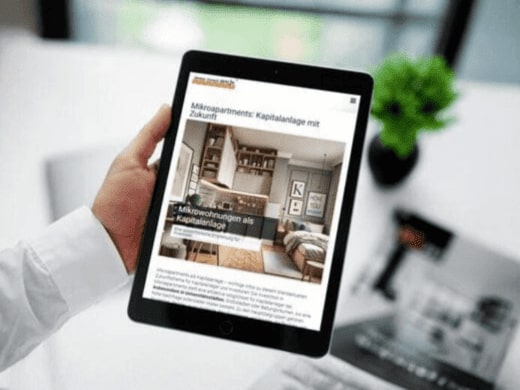 Investor liest am iPad Marktbericht zum Thema Mikrowohnungen. Berliner Immobilienmakler hat den Text beim Texter beauftragt.